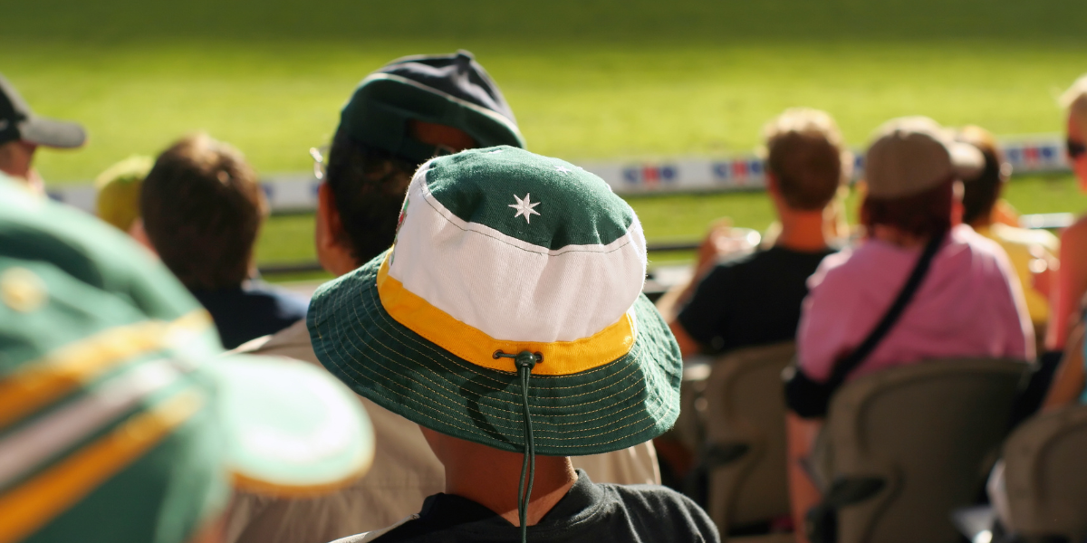 A young boy watches his team at a sports arena.